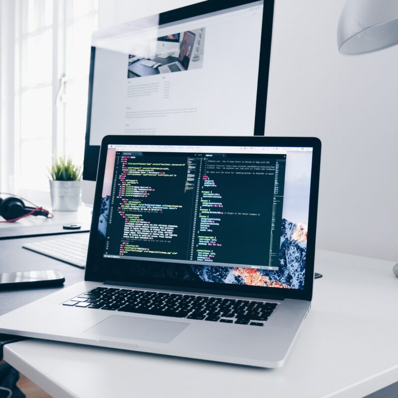 Laptop on desk with code