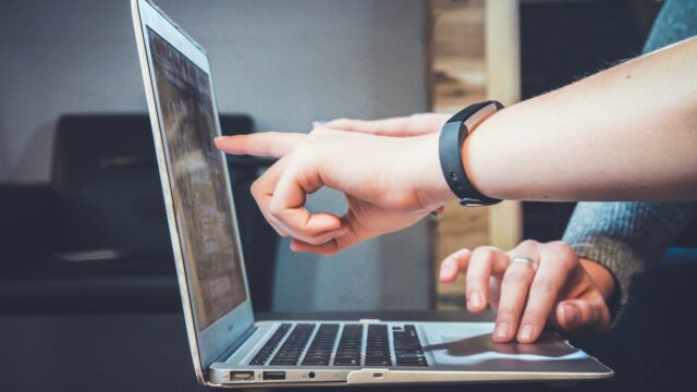 someone pointing at a computer