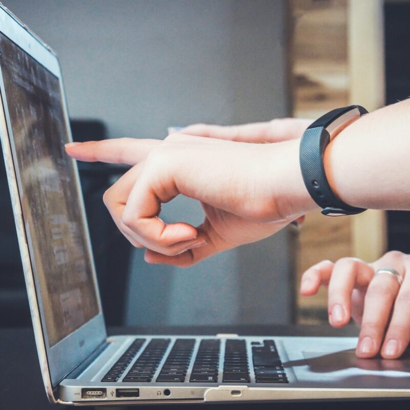 someone pointing at a computer